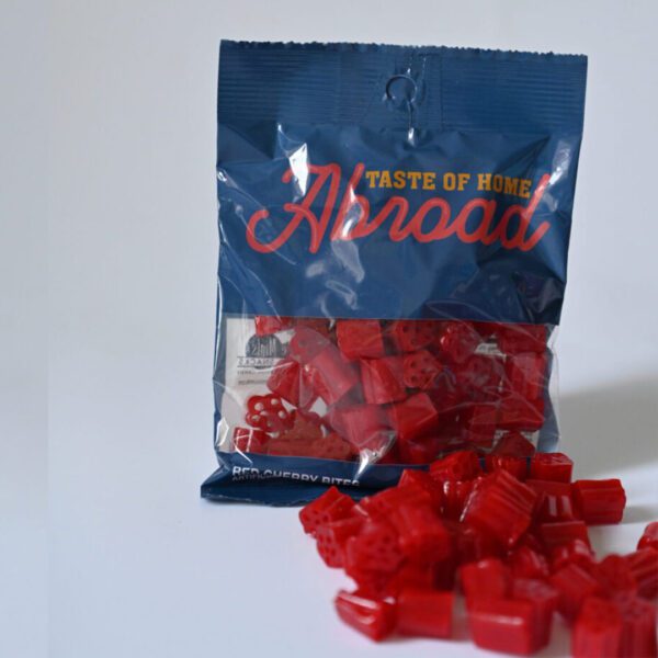 A bag of red candy sitting on top of a table.