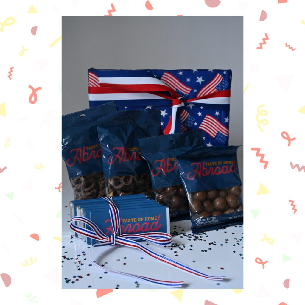Packages of chocolate-coated malt balls arranged in a celebratory setting with a patriotic theme.