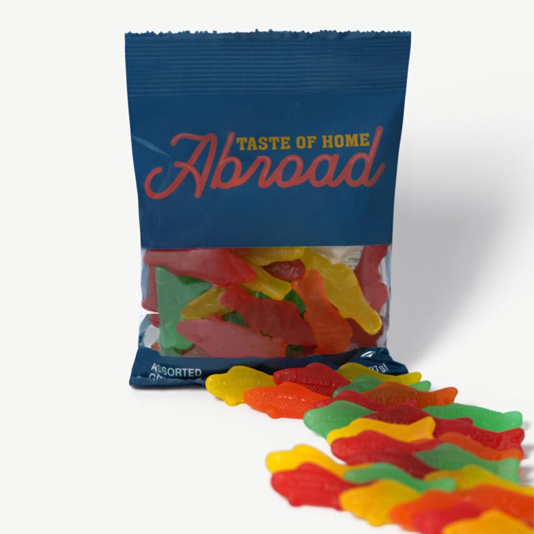 A bag of assorted gummy candies with some spilled out in front, labeled "taste of home abroad.