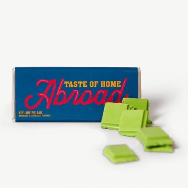 A box of green chewing gum next to some other pieces.