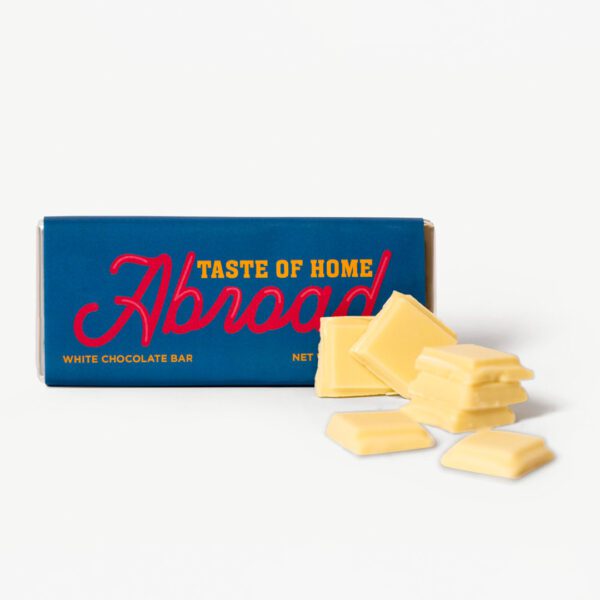 A box of cheese sitting next to some pieces.