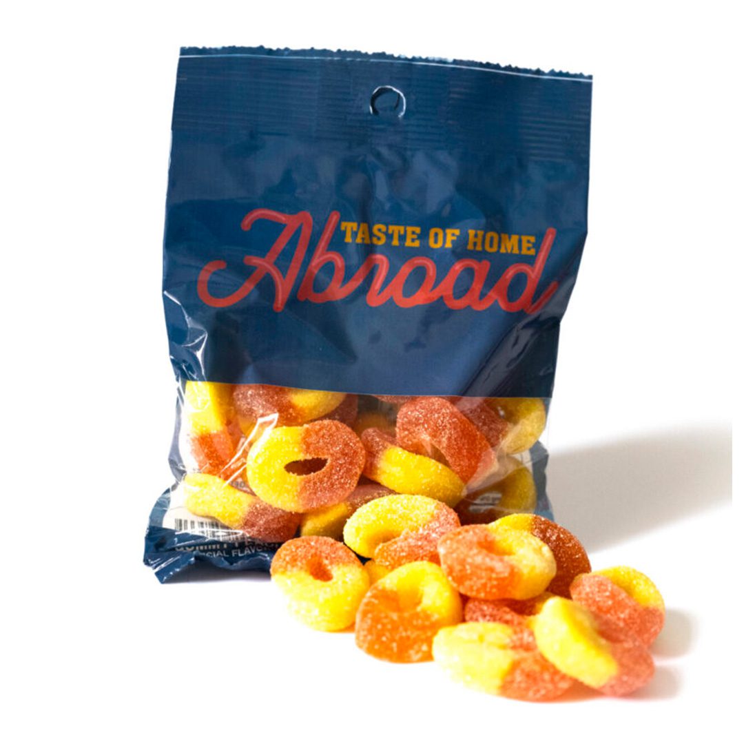 A package of "taste of home abroad" gummy candies spilling out onto a white surface.