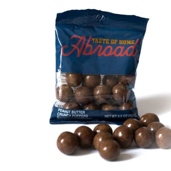 A bag of chocolate balls sitting on top of the floor.