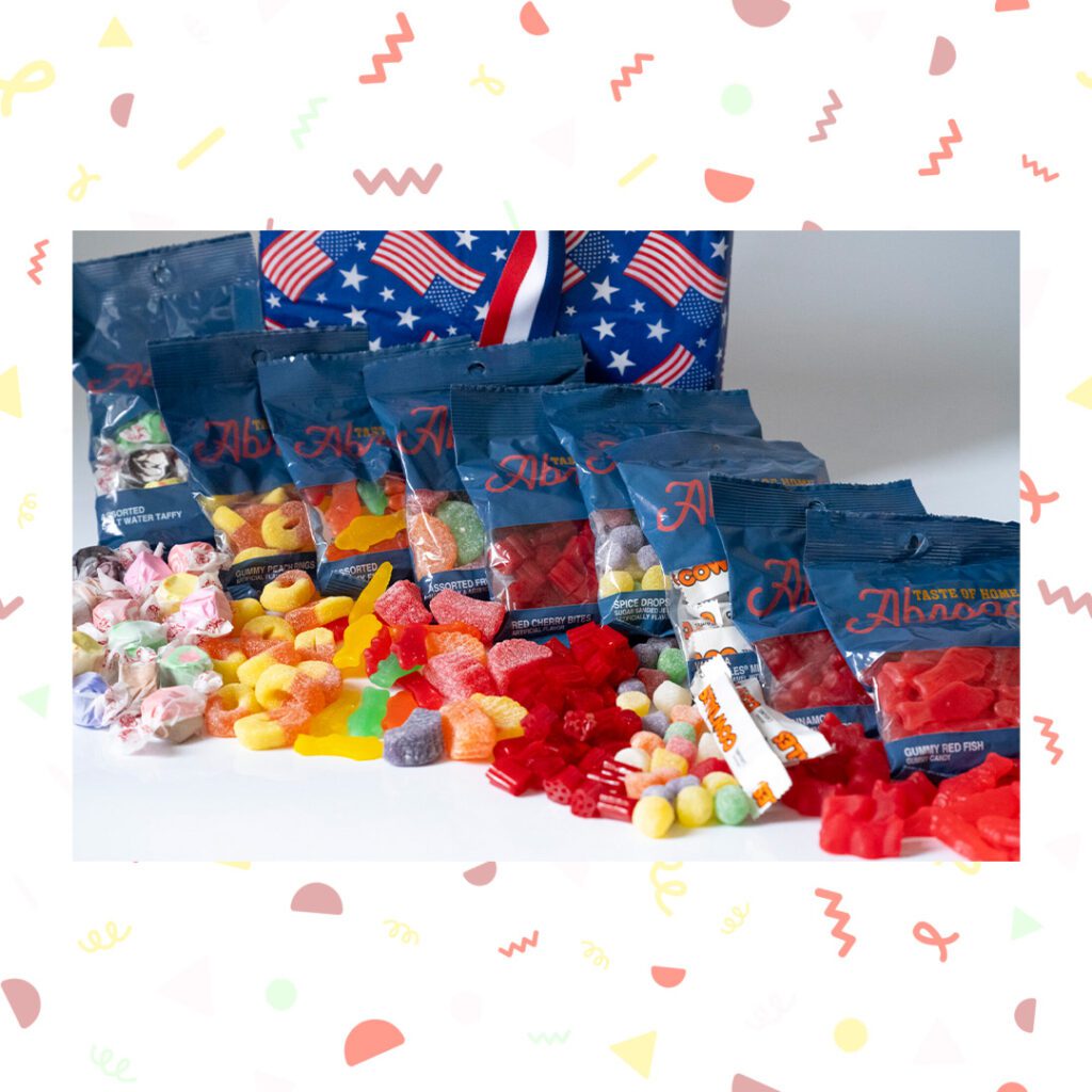Assorted candies and snacks displayed in front of a patterned backdrop.