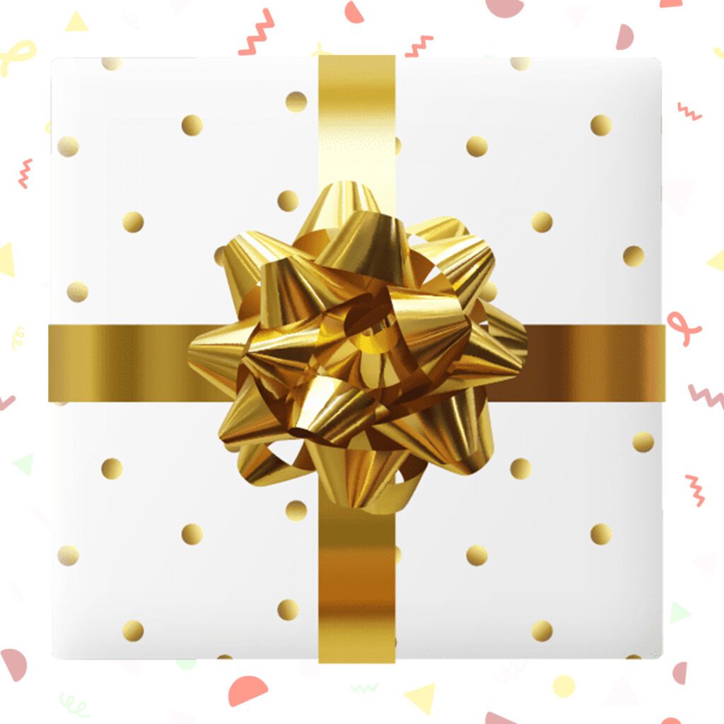 White gift box with gold ribbon and bow, adorned with confetti pattern.