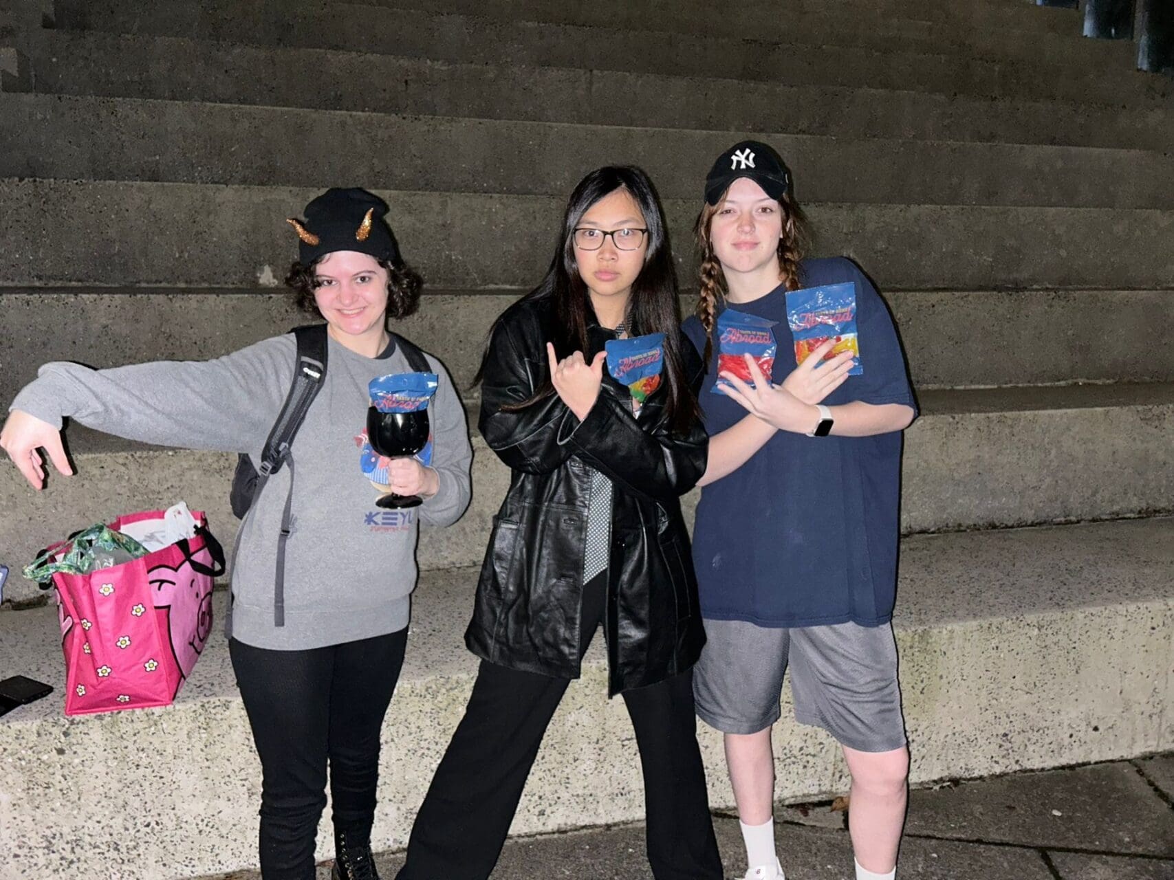 Three friends posing with candy.