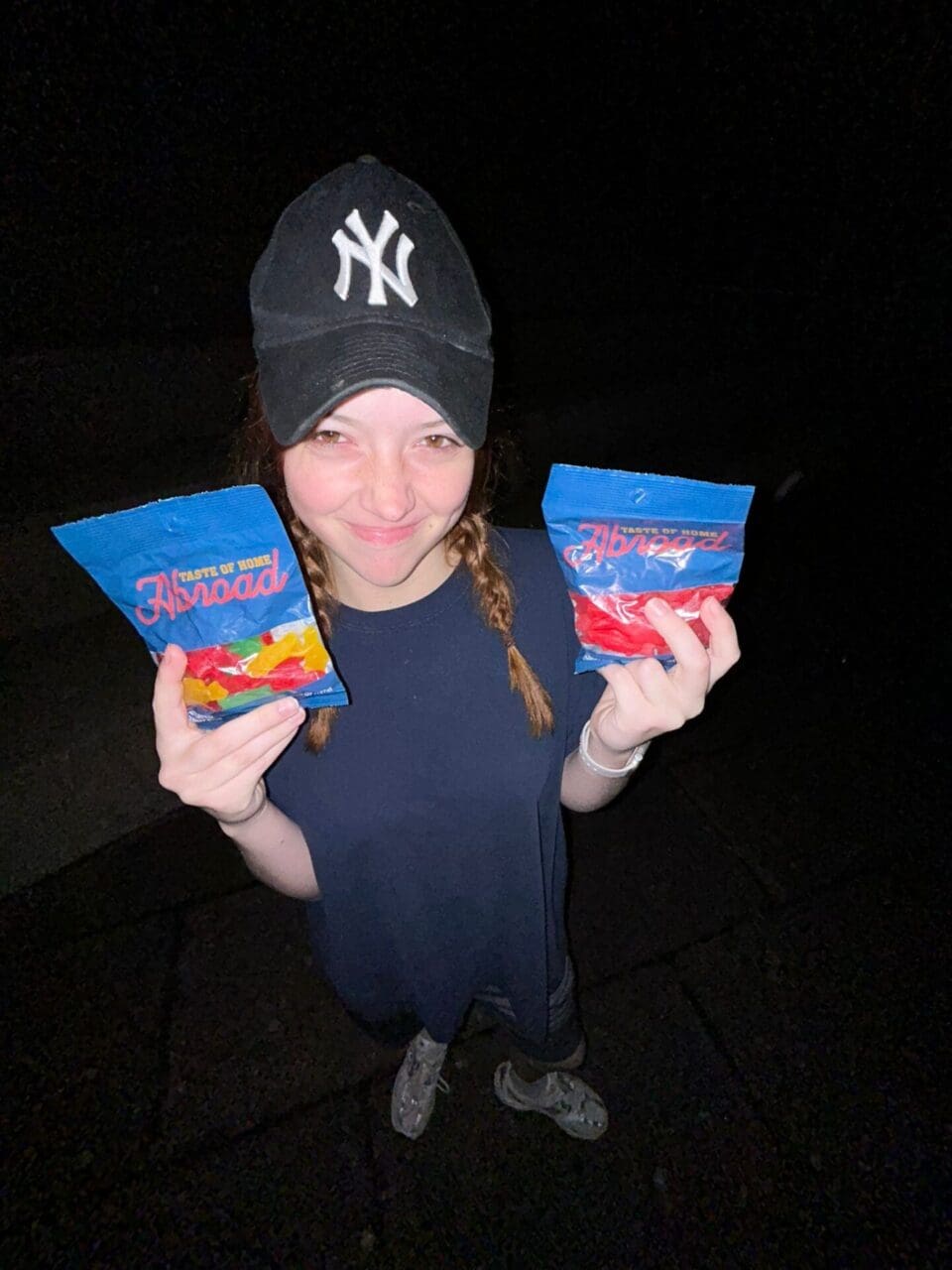 Woman holding two bags of gummies.