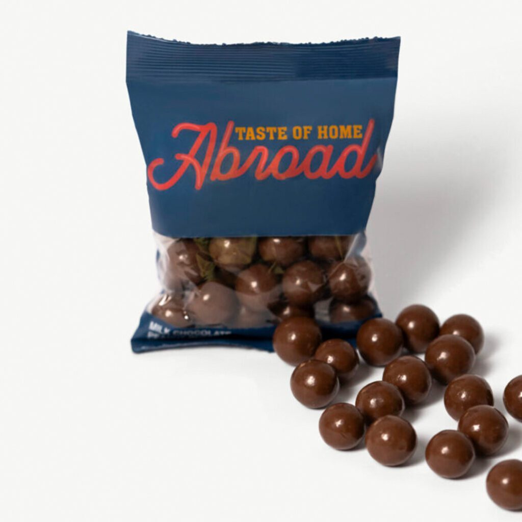 Packaged snack labeled "taste of home abroad" with chocolate-covered treats spilled out.